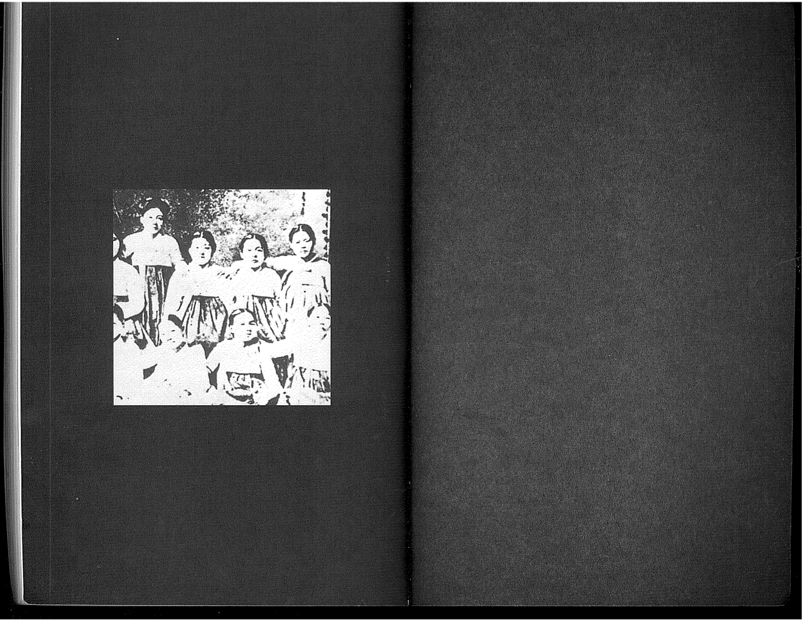 Page layout from Theresa Hak Kyung's Dictee. Both pages are black. On the left side of the page, there is a black and white image of a group of individuals in traditional Korean dress.