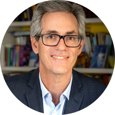 David N. Myers wears a collared light blue shirt under a navy suit jacket and smiles directly at the camera. He wears black glasses and has dark gray hair.