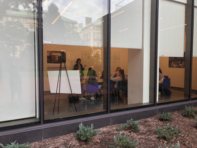 people gathering in the CEP, shown through the outside window 